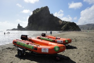 Piha Surf Life Saving Club IRBs with Lion Rock